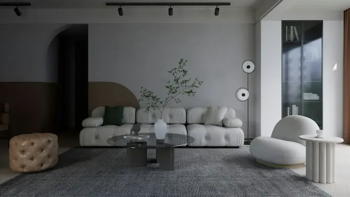 Architectural minimalist living room with dramatic arched wall alcove, oversized cream bouclé sofa, and black-framed doorways