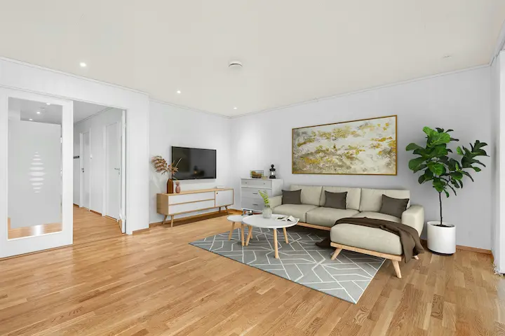 Minimalist living room with cream curved sofa, large abstract art, and light wood flooring.