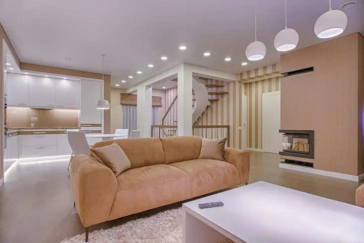 Modern ceiling LED panel lights illuminating a luxury living room.