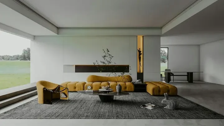 Modern minimalist living room with bold yellow modular sofa against gray textured wall panels and polished concrete floors