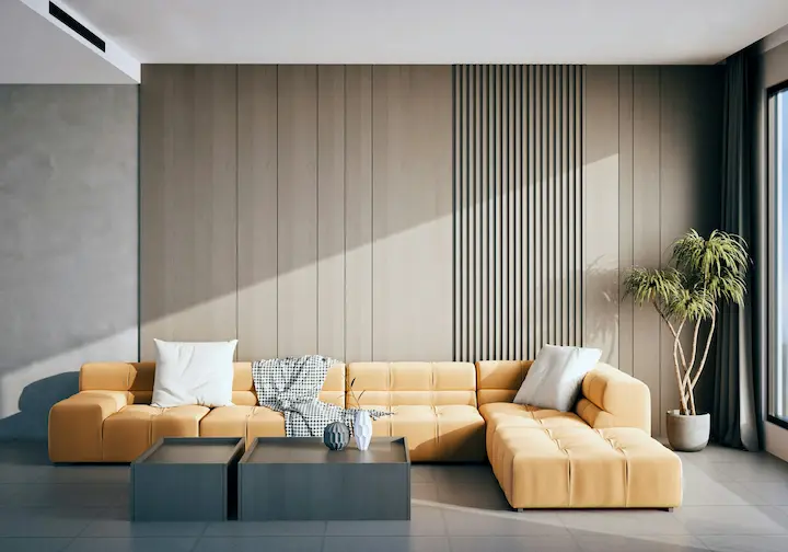 Modern living room with a vibrant yellow sofa, white walls, and minimalistic decor.