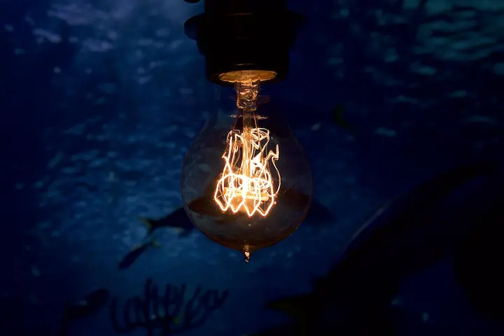 Decorative vintage LED bulb hanging from ceiling fixture.