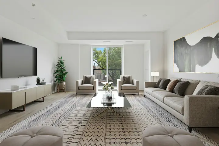 Minimalist living room with white walls, black and white rug, and wood-framed glass windows.