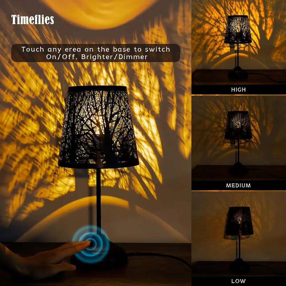 Decorative shadow lamp projecting warm tree branch patterns on white bedroom wall