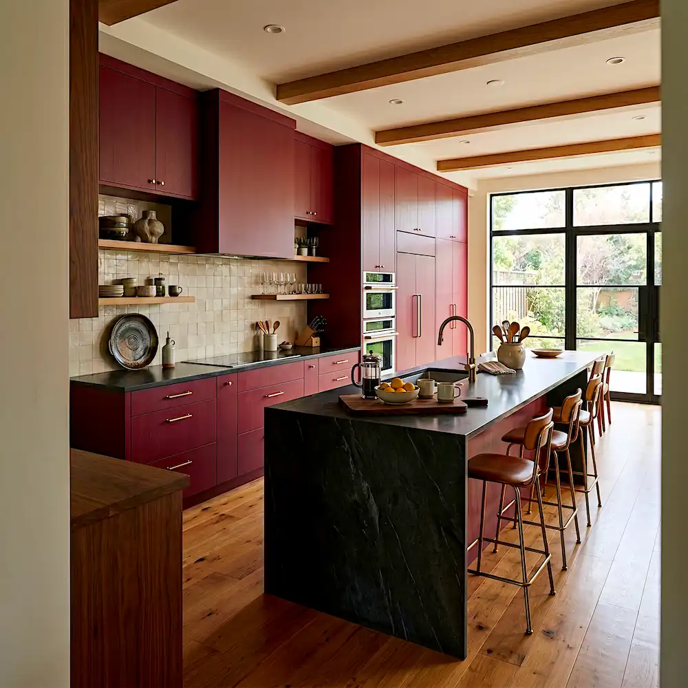 Modern deep red kitchen with walnut wood accents and black marble countertop