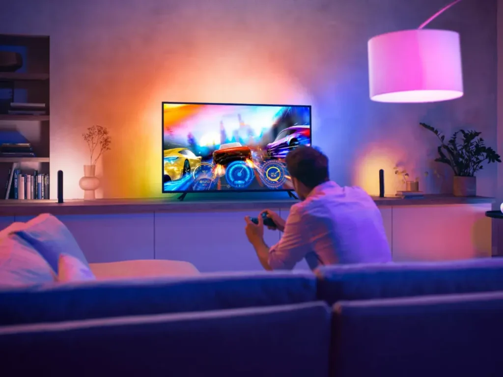 Philips Hue Play Gradient Lightstrip illuminating a TV with multicolor effects